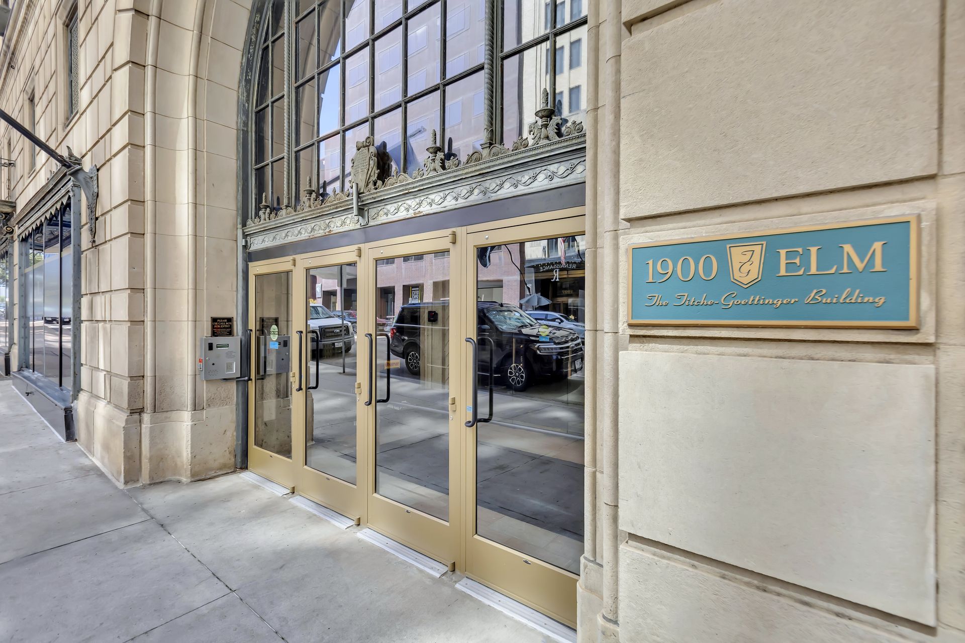 Entrance doors of 1900 Elm beneath decorative metalwork
